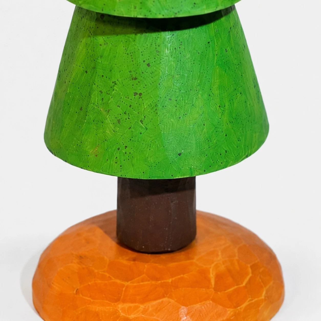 Carved green tier and wood trunk detail
