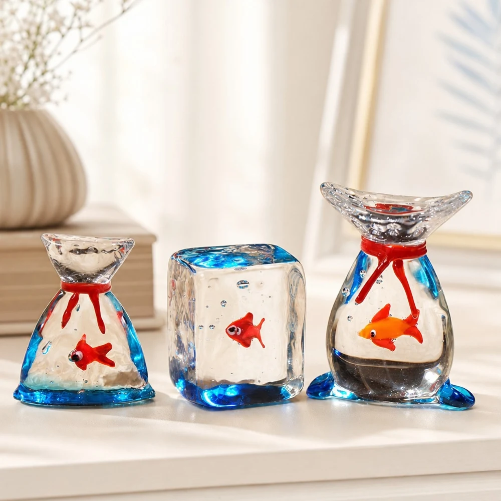 Three handmade glass goldfish ornaments displayed together