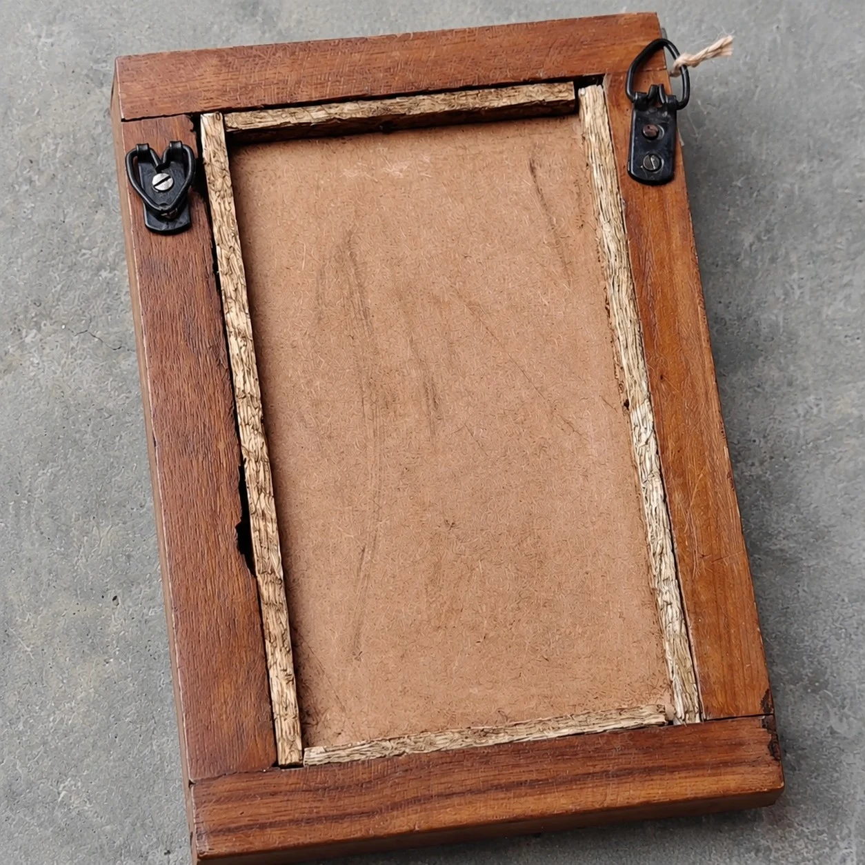Back side of the mirror showing hanging hardware