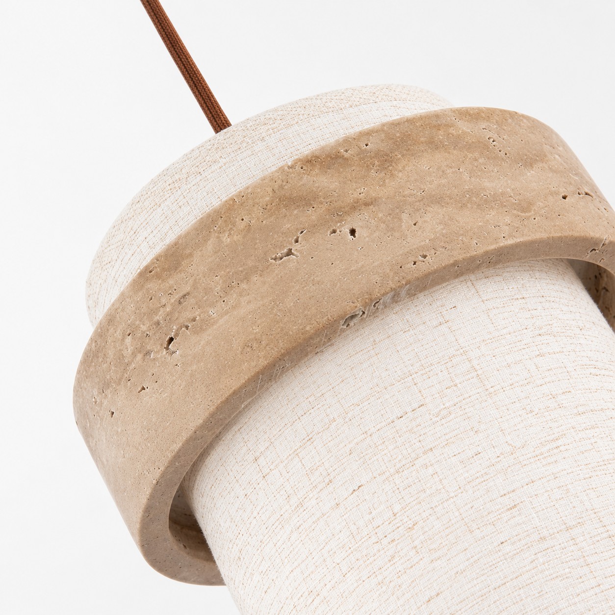 Close-up of travertine and fabric shade