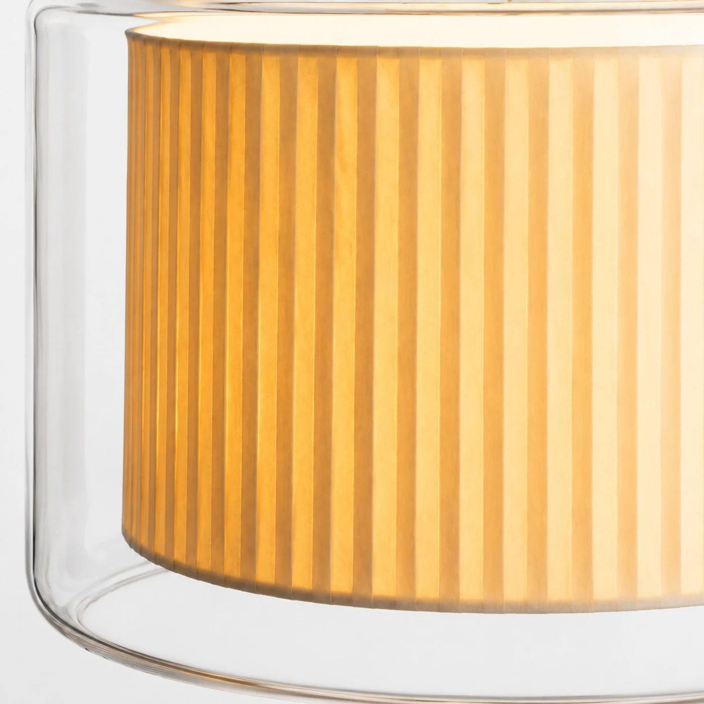 Close view of pleated fabric shade through clear glass