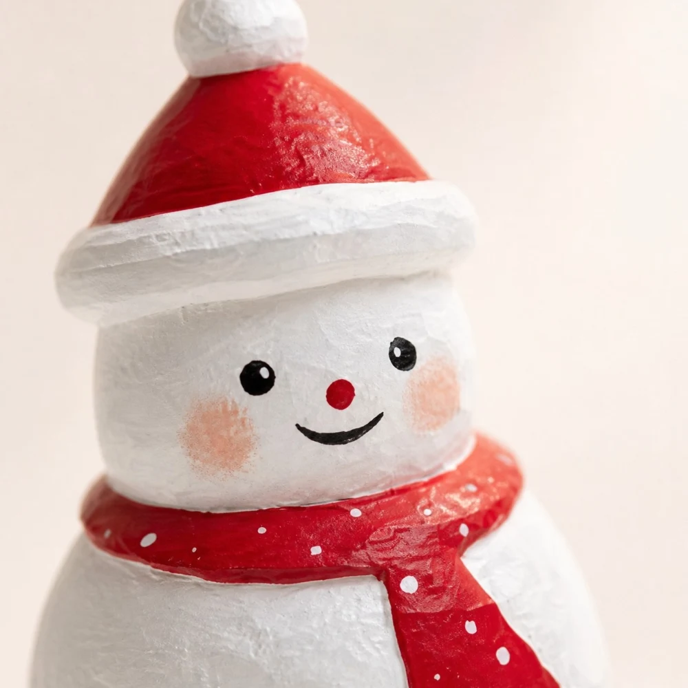 Close detail of handmade wooden snowman face and scarf