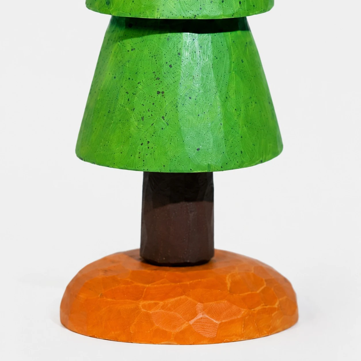 Orange carved base and trunk detail