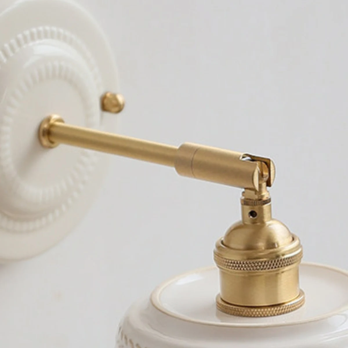 Brass tone arm and shade connection detail