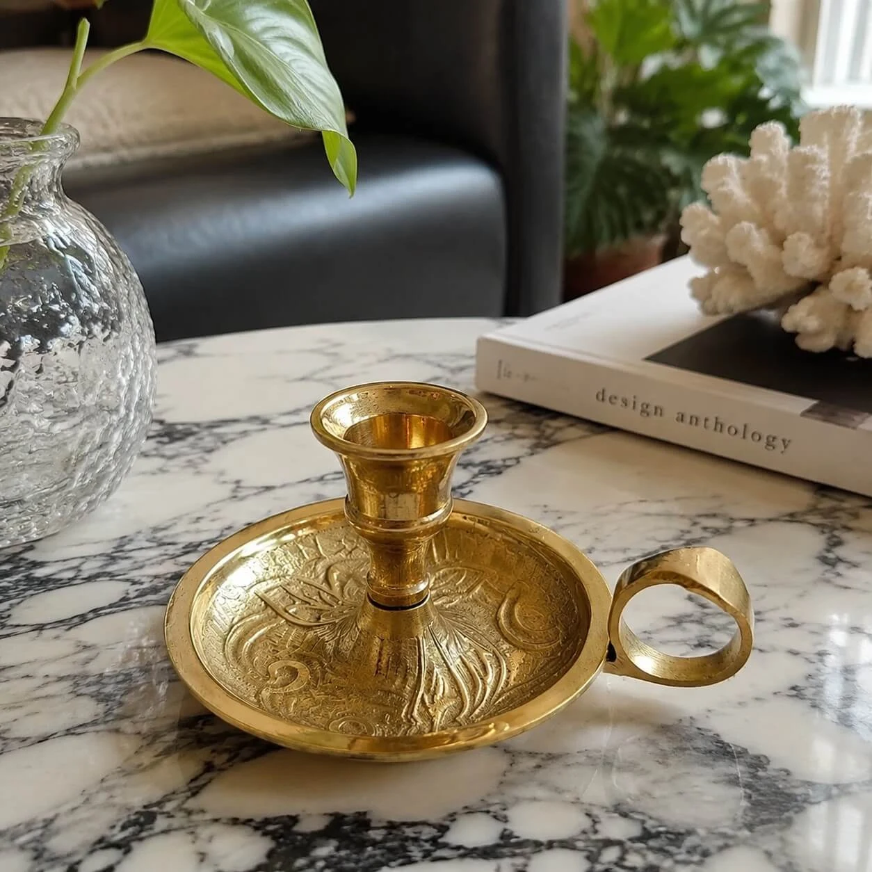 Handmade brass candlestick styled on a marble table