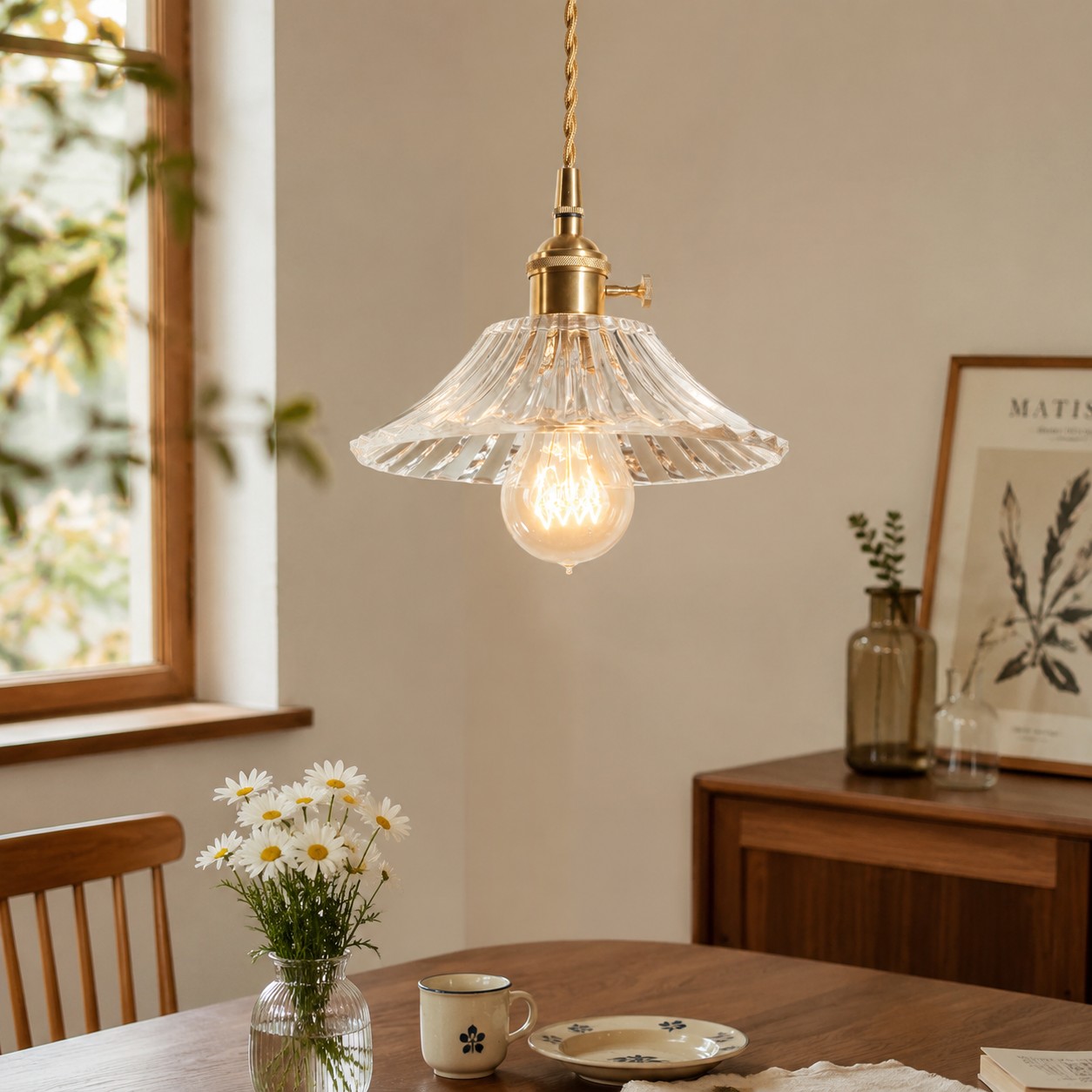 Style I flared clear glass pendant above a dining table