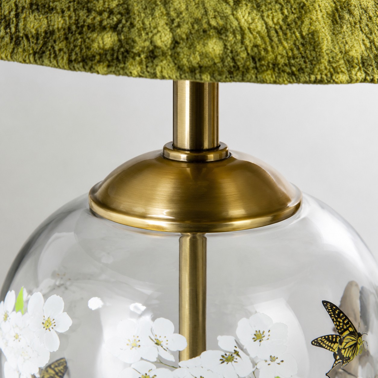 Close view of the brass tone hardware and glass lamp body