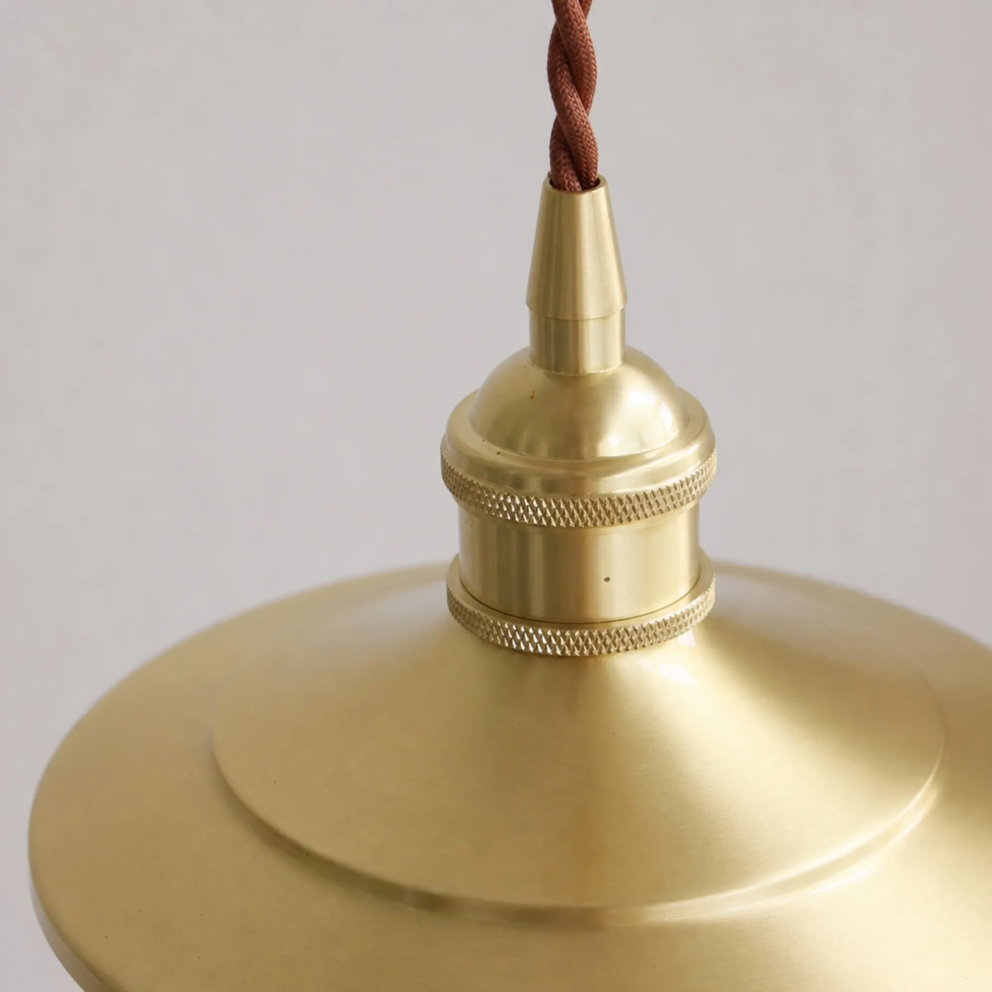 Close-up of the polished brass socket and knurled rings