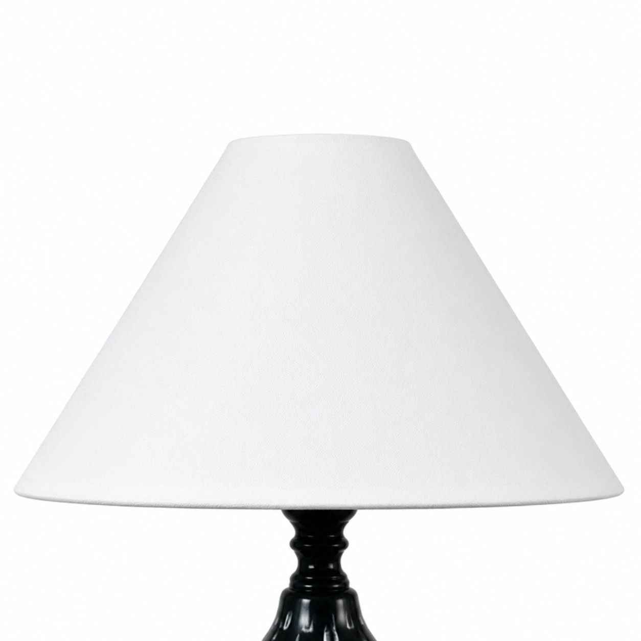 White fabric shade detail on ceramic table lamp