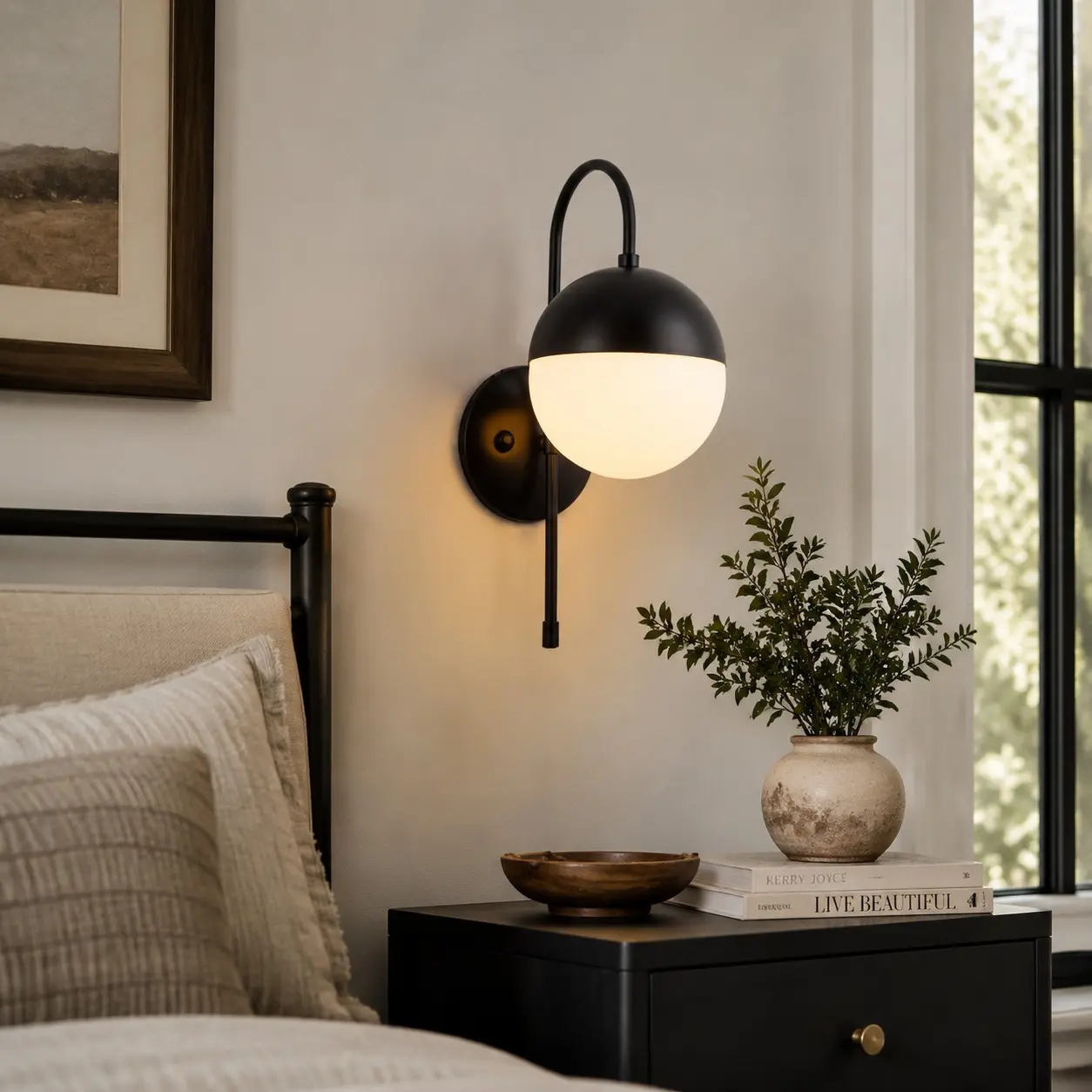 Black milk glass wall lamp beside a bed