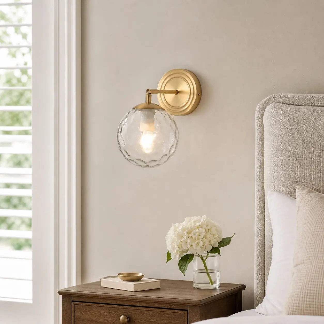 Rippled glass wall lamp in a warm neutral bedroom