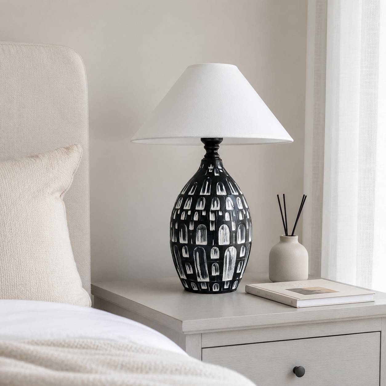Black ceramic table lamp on a bedside table