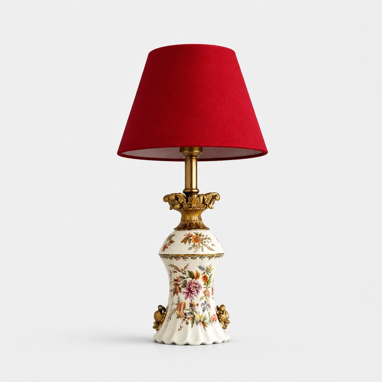 Red floral ceramic table lamp on a light background