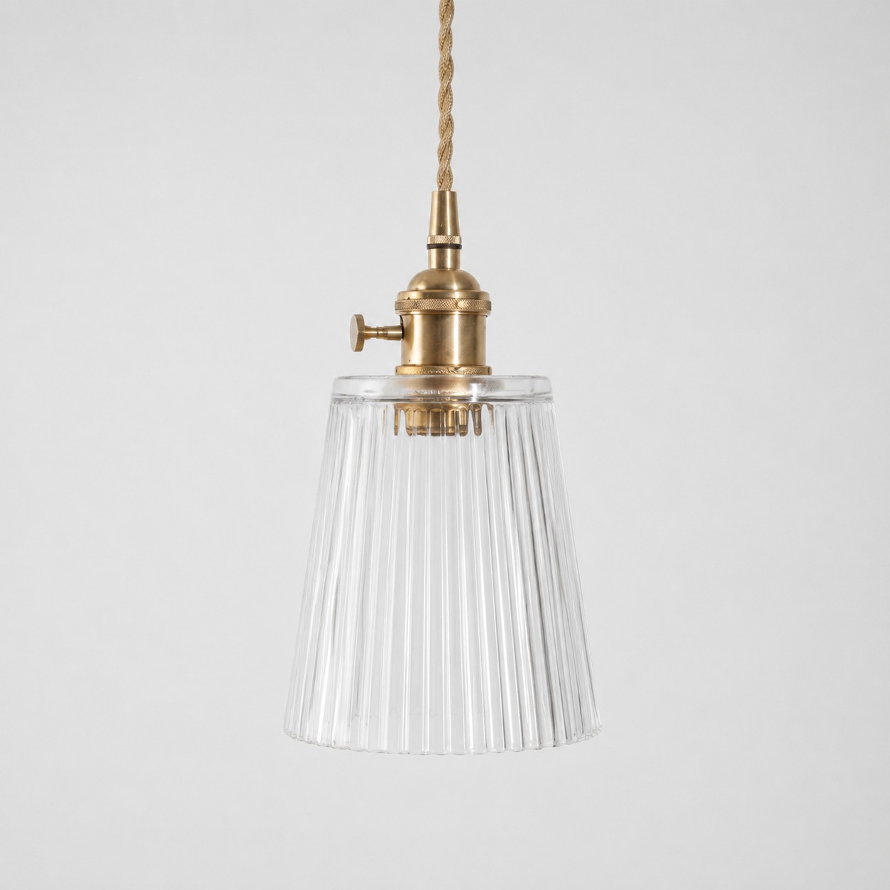 Style L - Clear textured glass shade with antique brass E27 socket, front view