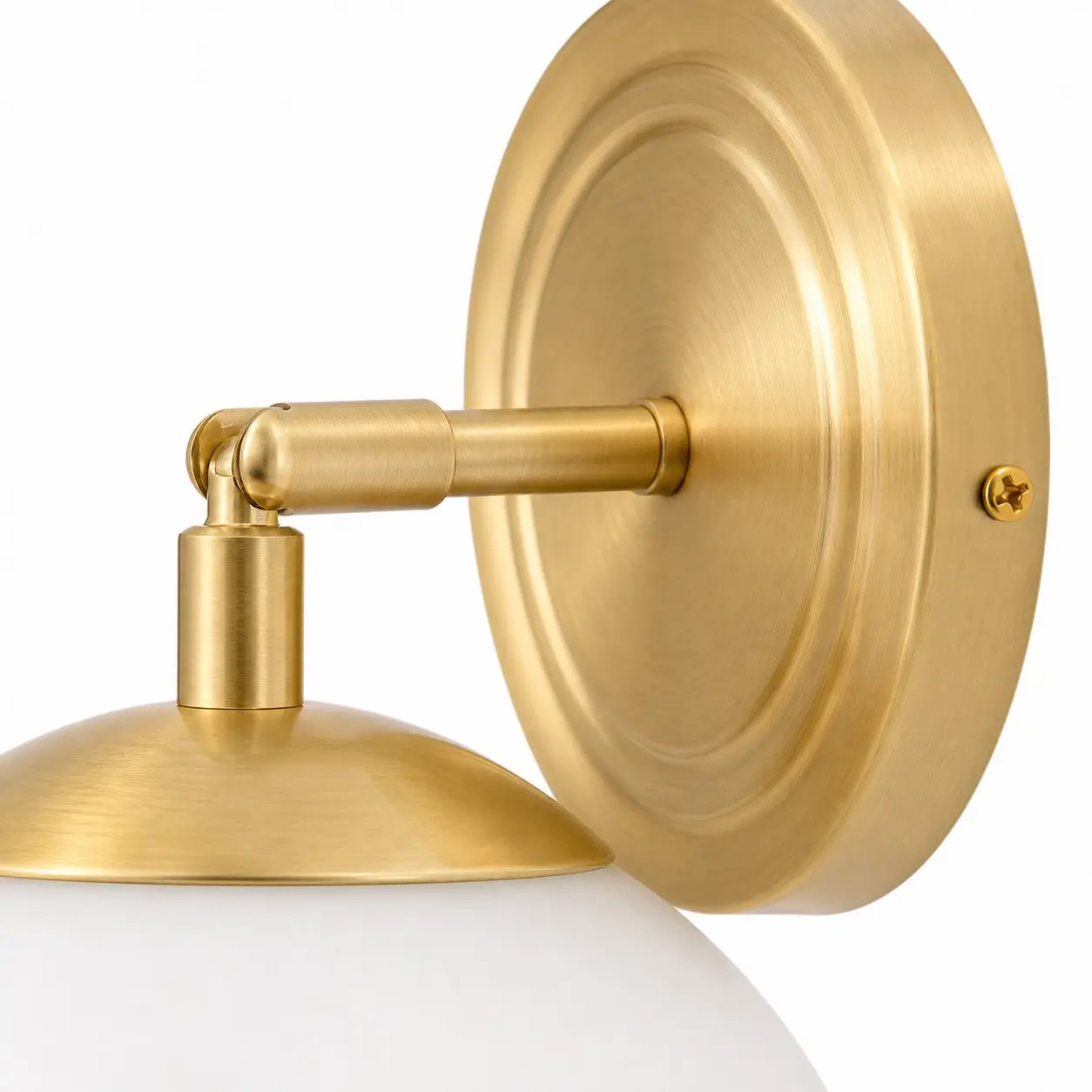 Brushed gold wall plate and articulated lamp arm detail