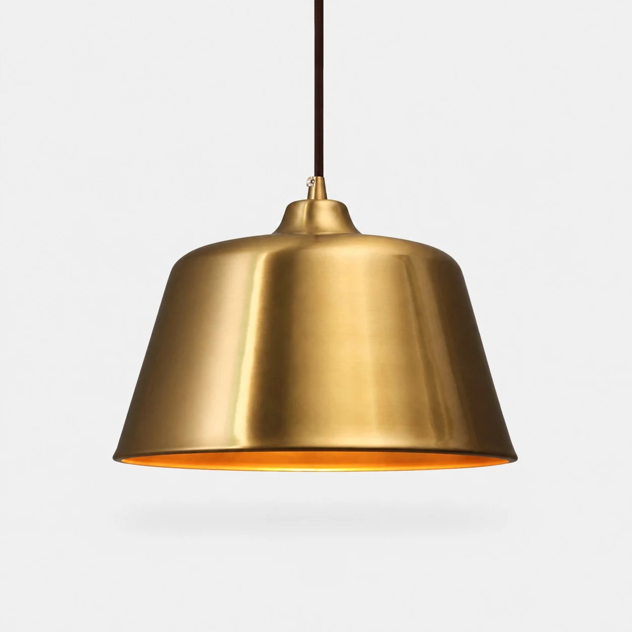 Bright Brass bell pendant lamp on a clean background