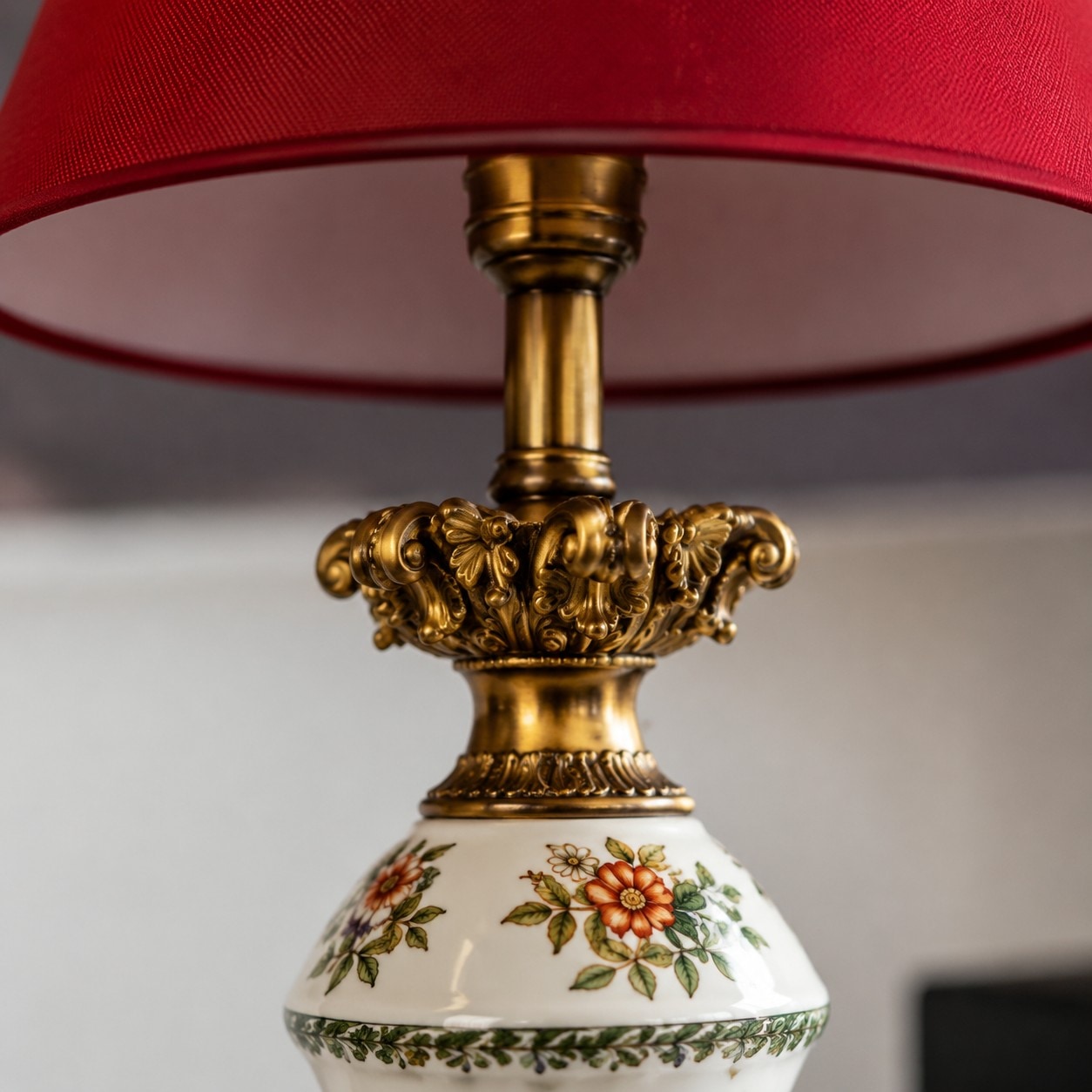 Antique metal detail below the red lampshade