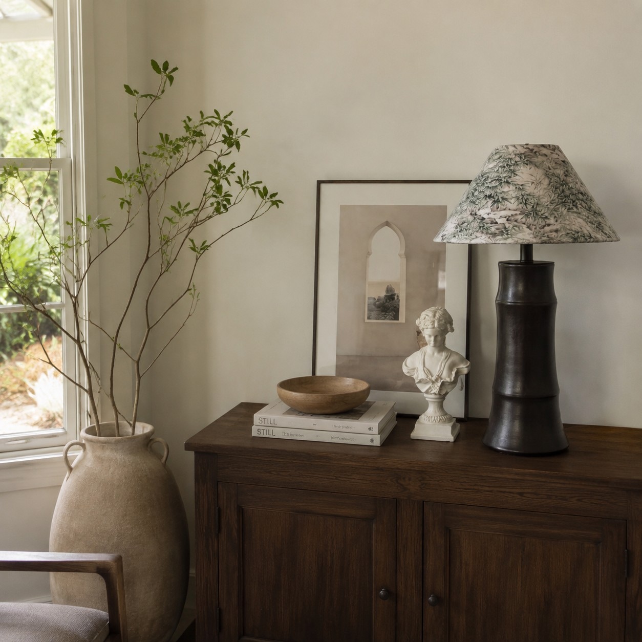 Dark ceramic table lamp styled on a wooden console