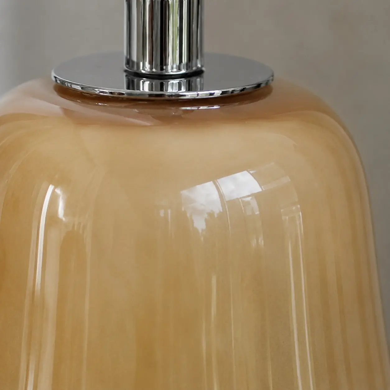 Chrome-finish top connector on the glass shade