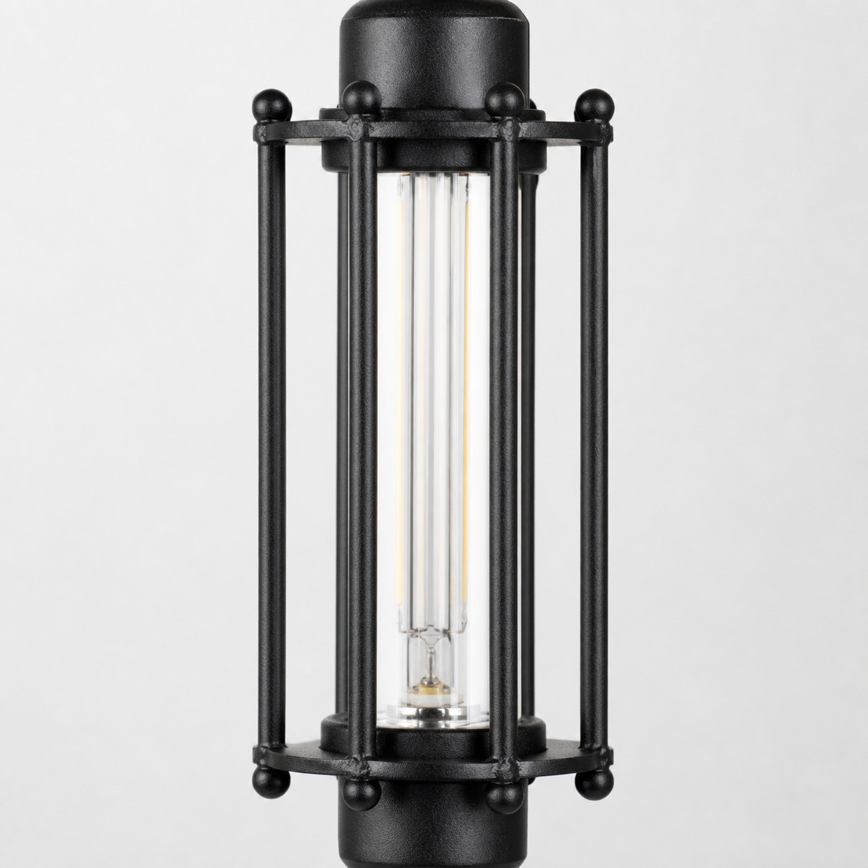 Close view of black tube guard frame and glass shade