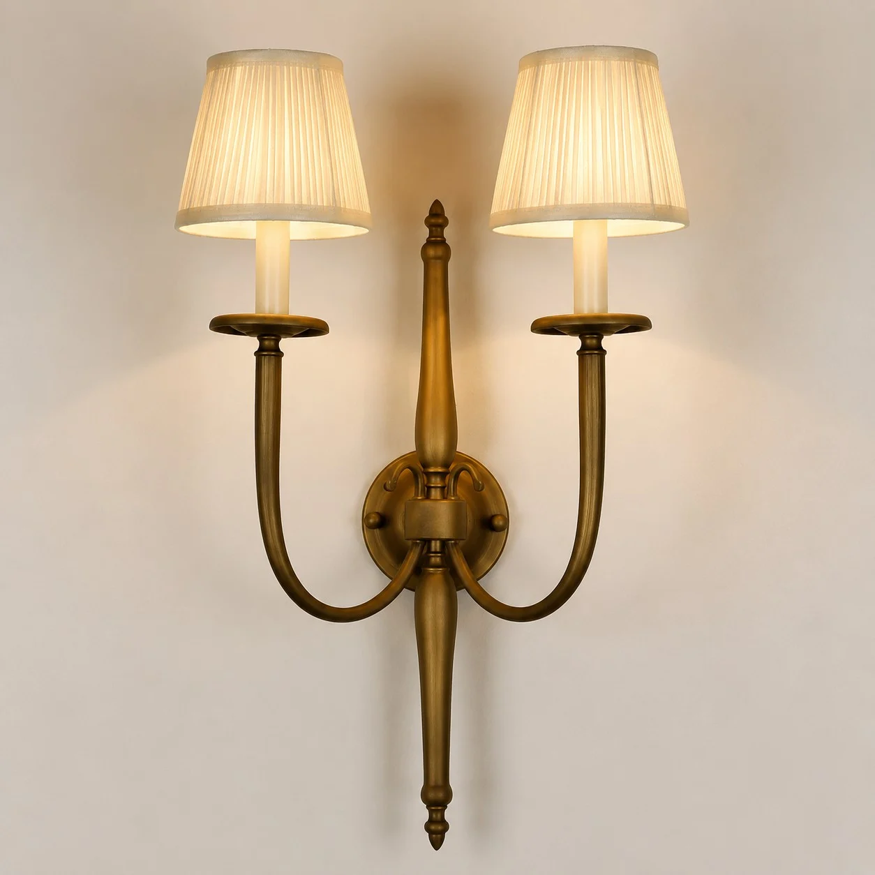 Front view of double arm wall sconce with pleated fabric shades